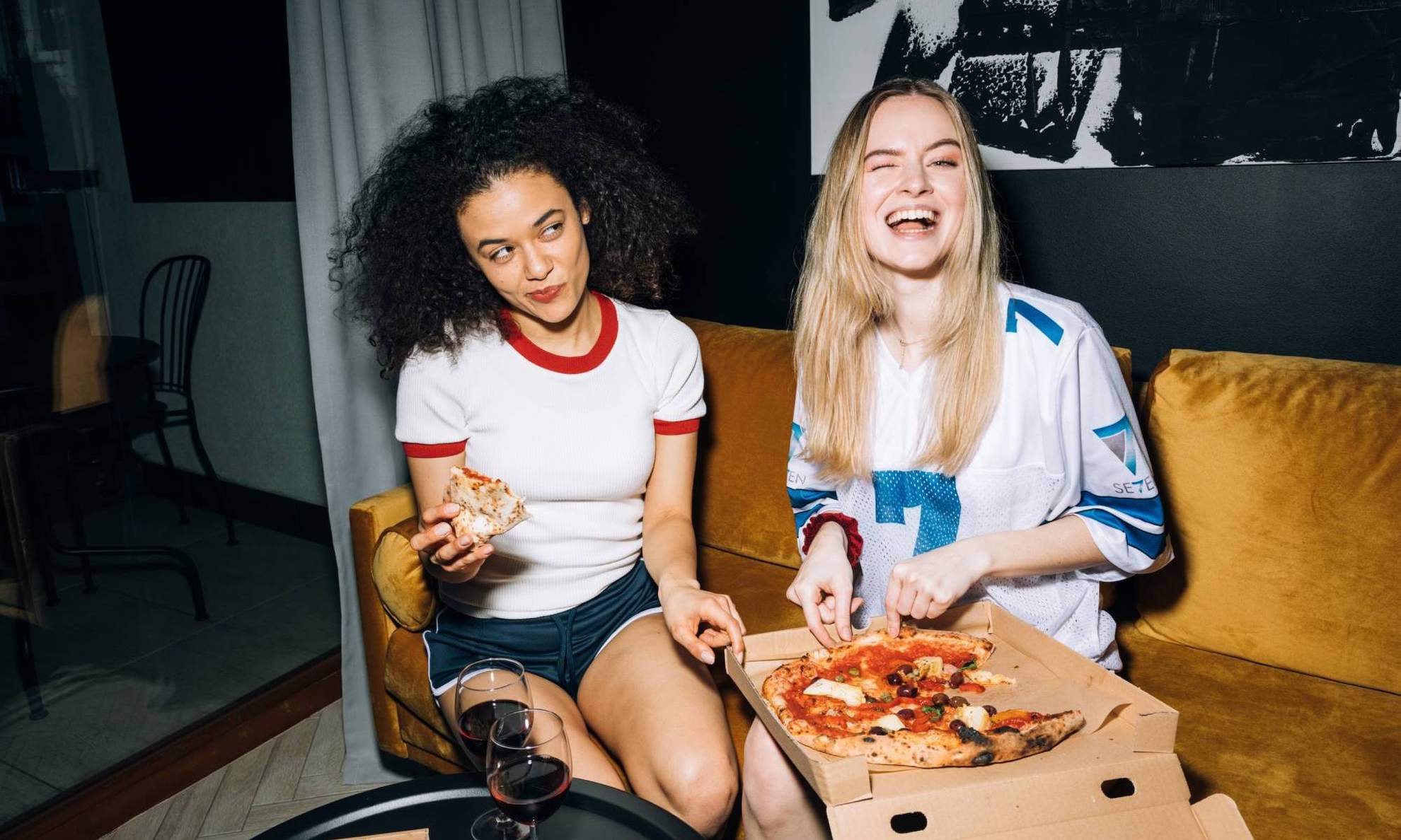 Довольные подружки едят пиццу